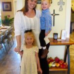 Smiling mother with two children indoors